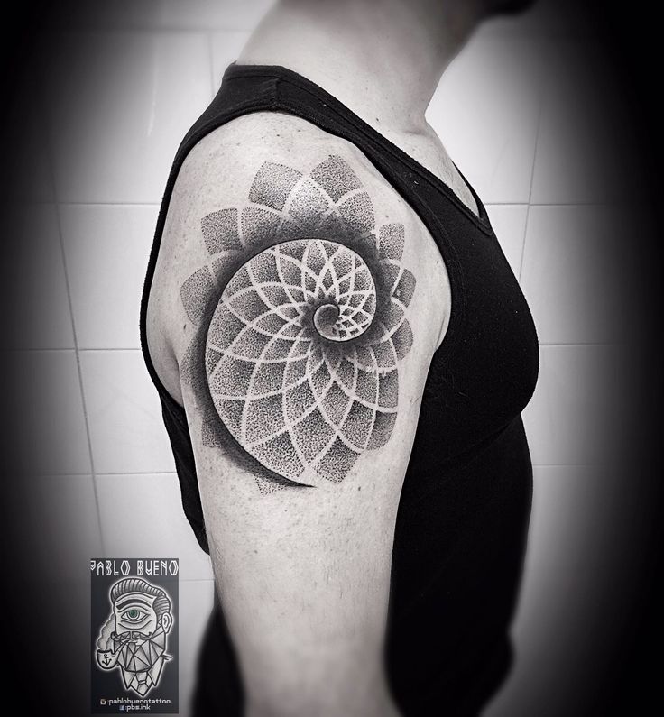 a black and white photo of a woman's arm with a flower tattoo on it