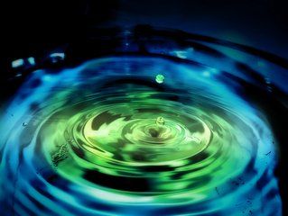 a green and blue swirl in water