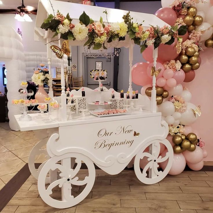 an ice cream cart decorated with balloons and flowers