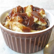 a bowl filled with bread and pudding on top of a table