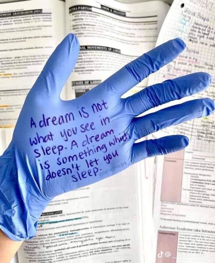 a hand in blue gloves with writing on it that says, dream is not what you see in sleep