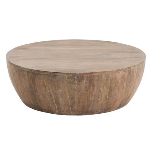 a round wooden table sitting on top of a white floor