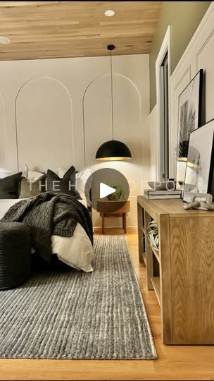 a large bed sitting in a bedroom on top of a wooden floor