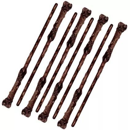 six wooden dowels are lined up on a white background