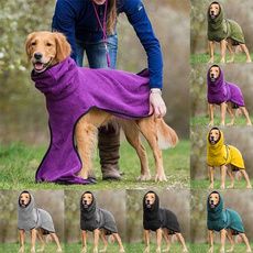 the dog is wearing a purple blanket on it's back and standing next to its owner