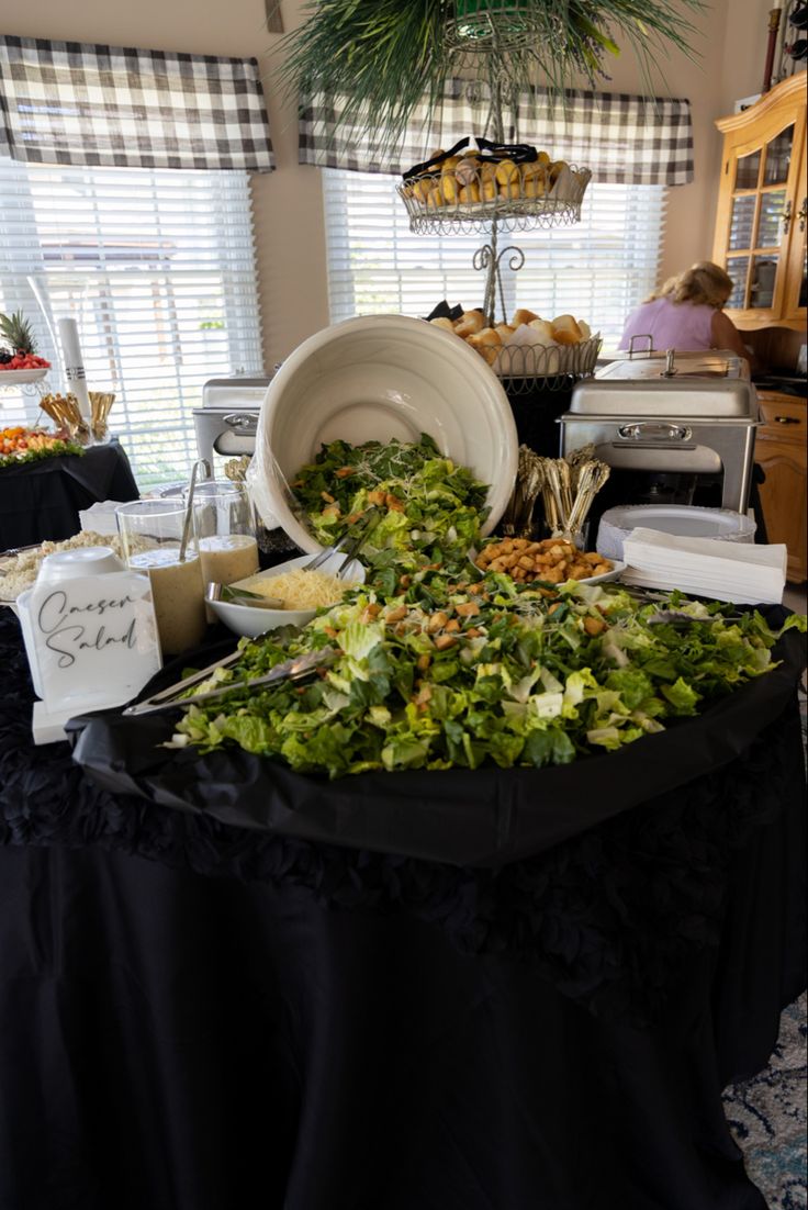 a table covered in lots of different types of salads and other food on top of it