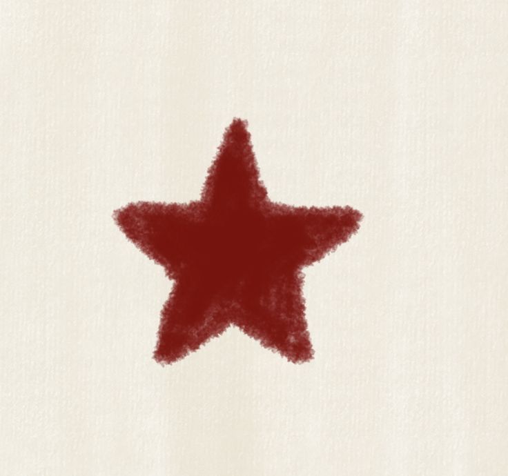 a red star drawn on top of a white paper with the word written below it