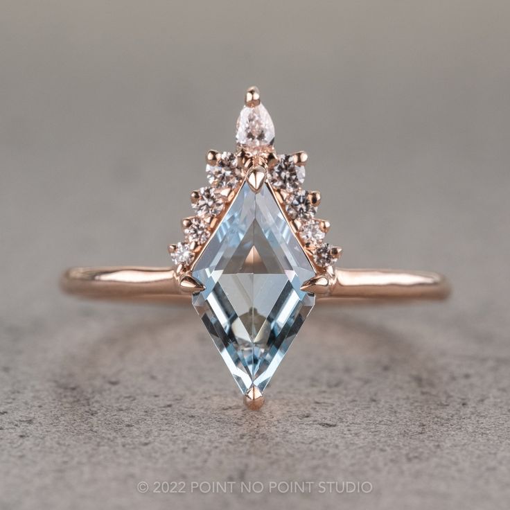 an engagement ring with a blue topazte and diamond accents