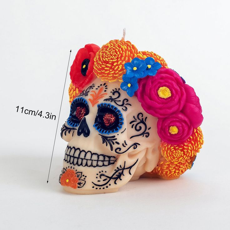 a sugar skull with flowers on it's head is shown in front of a white background