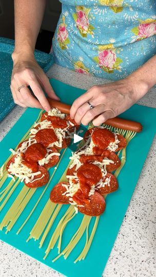 a woman cutting up some food on top of a blue mat