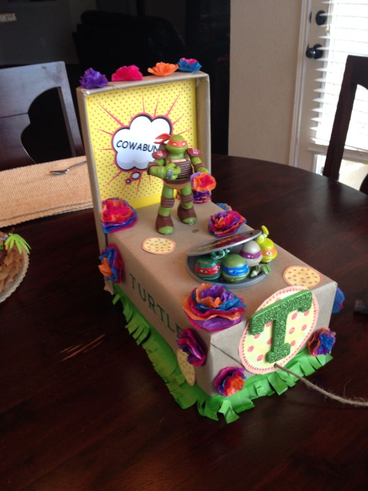 a birthday cake made to look like a box with decorations on the top and sides