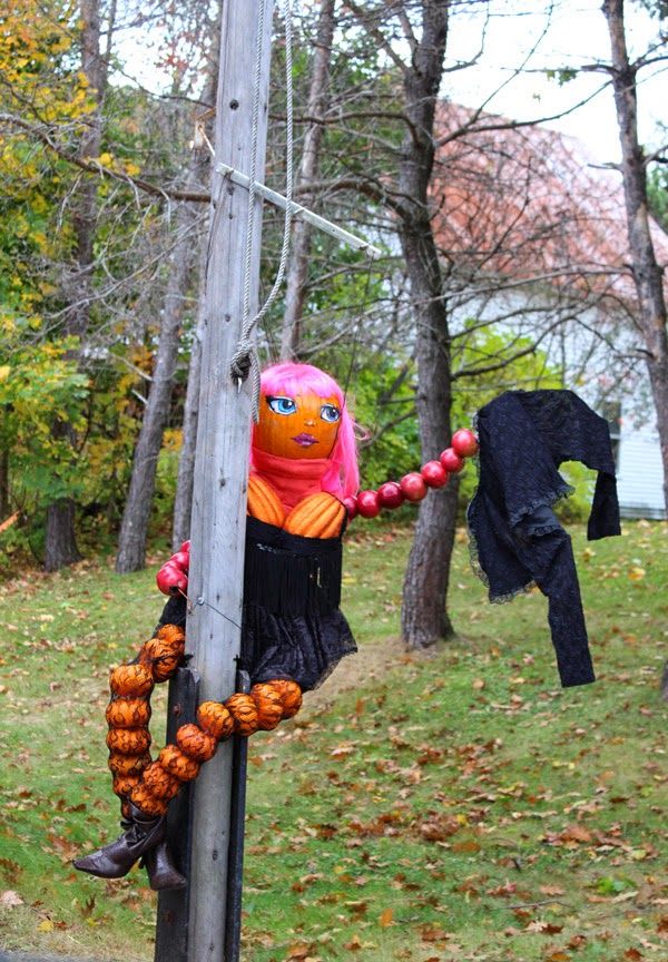 an odd looking stuffed animal hanging from a pole