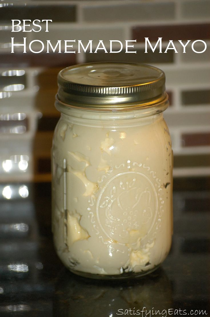 a jar filled with homemade mayonnaise sitting on top of a counter