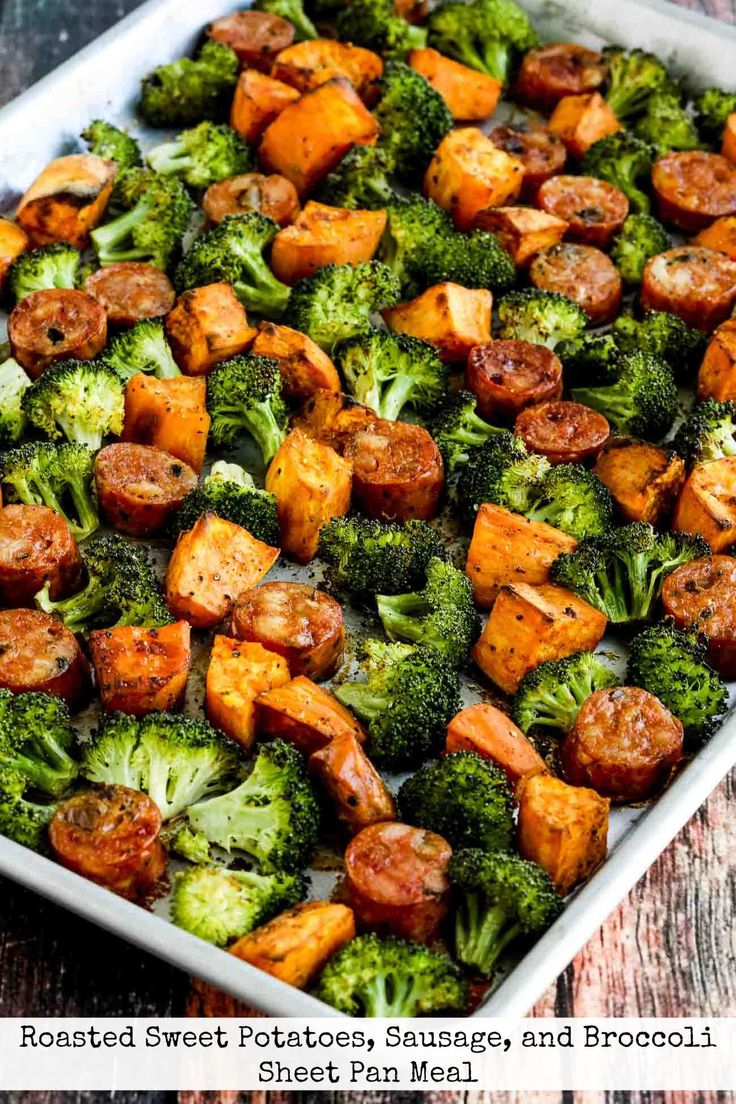 roasted sweet potatoes, sausages and broccoli in a white dish on a wooden table