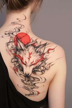 the back of a woman's neck with a wolf tattoo on it