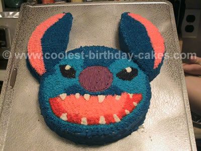 a birthday cake that looks like a cartoon character with big teeth and fangs on it's face