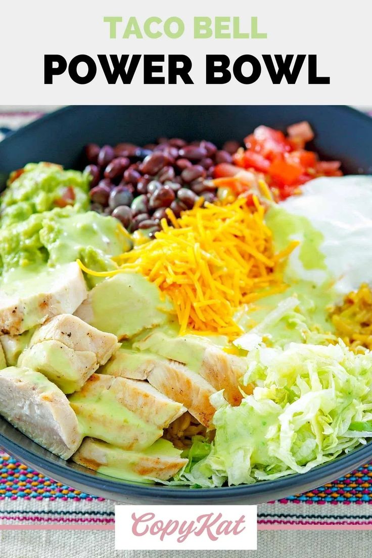 a salad with chicken, beans, avocado and sour cream dressing in a bowl