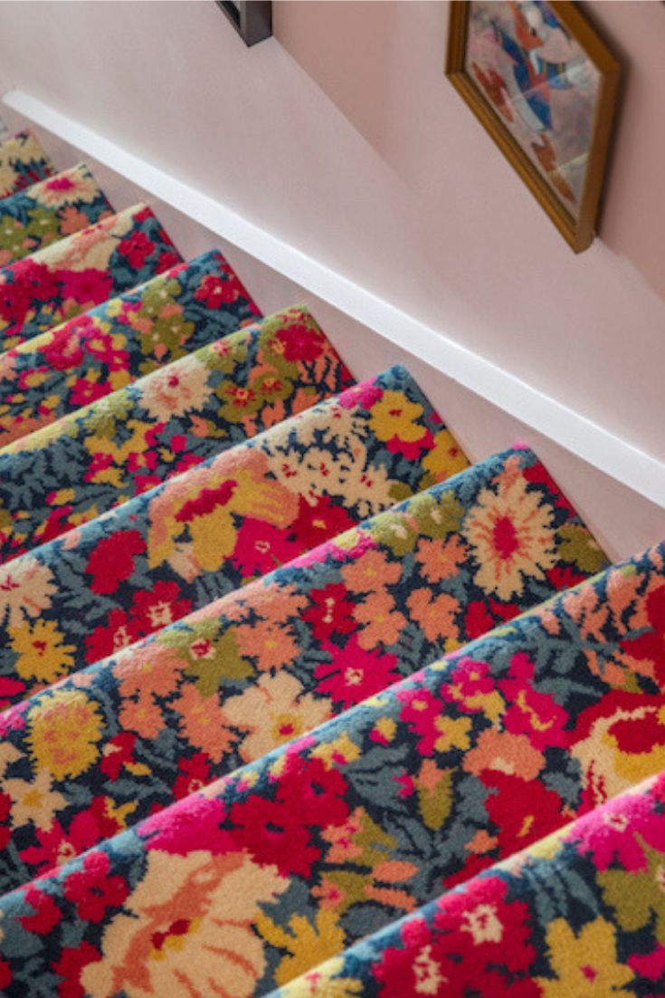 the carpeted stairs are lined with colorful flowers