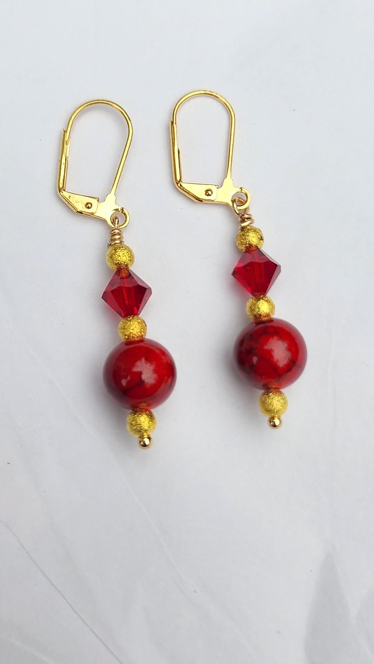 Beautiful gold-plated earrings made with bright red glass crystal beads. Nickel free Red Ear Wire Jewelry For Holidays, Red Dangle Jewelry With Faceted Beads, Red Nickel-free Drop Crystal Earrings, Red Gold Plated Earrings For Party, Holiday Jewelry With Dangling Beads, Red Ear Wire Earrings For Holiday, Red Round Beads Earrings For Christmas, Red Beaded Crystal Drop Earrings, Red Beaded Drop Crystal Earrings