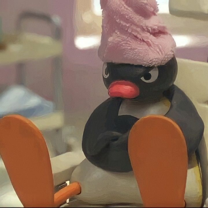 a toy penguin with a pink hat and skis on it's head sitting in a chair