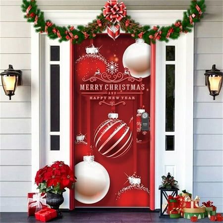 a red front door decorated with christmas decorations