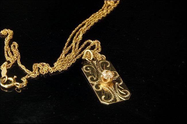 "This is a very beautiful, vintage and unique DIAMOND 14K GOLD pendant necklace (weight 3.2). The necklace has a marvelous engraved decoration, brilliant cut diamond (3.5 mm) and 14K gold (bottom has S-I 14KT) and chain (bottom has 14K). The necklace has a very extravagant and elegant feel to it. It measures 1\" x 7/16\" pendant and 21 1/2 long chain. The necklace is in very good condition. 0.7 MR" Antique Gold Necklaces With Single Cut Diamonds, Elegant Engraved Diamond Necklace, Vintage Diamond Necklace In Yellow Gold, Antique Yellow Gold Necklace With Diamond Accents, Formal Engraved Pendant Diamond Necklace, Formal Engraved Diamond Pendant Necklace, Engraved Diamond Pendant Necklace For Formal Occasions, Vintage Pendant Diamond Necklace With Single Cut Diamonds, Victorian Engraved Diamond Necklace