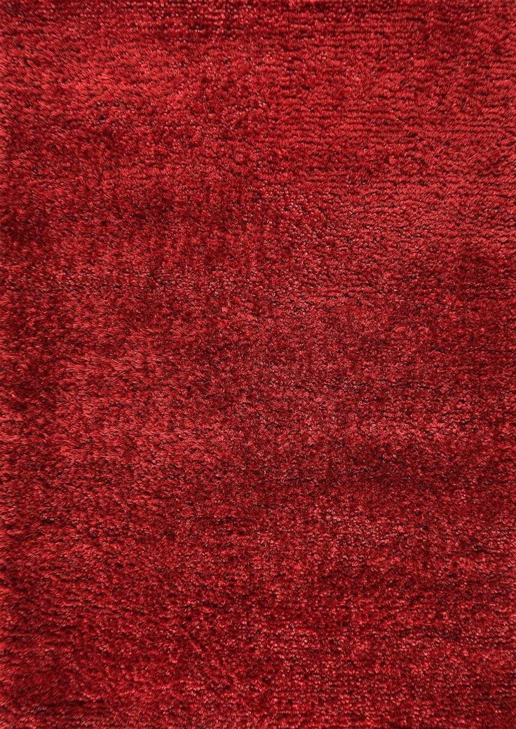 a red area rug with an uneven design