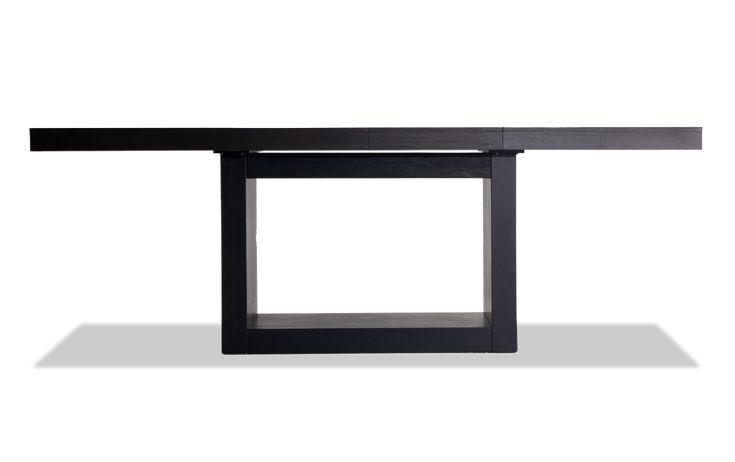 a black table sitting on top of a white floor