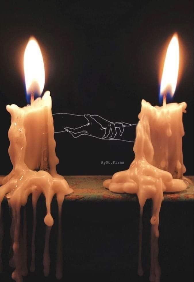 three candles with melting wax on them in the shape of hands and feet, against a black background