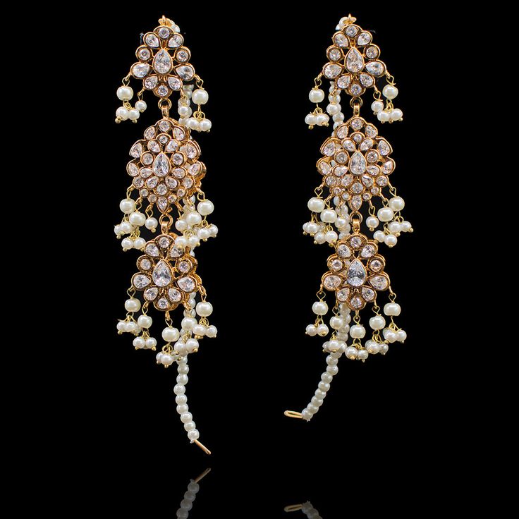 Make your wedding a little more special in our Rabiah Earrings! Beautiful earrings handcrafted with shimmering CZ stones and interlaced with pearl moti. Approximate earrings length is 3.5". Pair Rabiah Earrings with Rabiah Jhoomar for a complete festive look. Gold-plated on high-quality brass as base metal. Made by order. Kindly allow 4-6 weeks for the delivery of this item. For custom or urgent requests, please contact support@alacouture.com. *Please Note: We use faux stones and beads in all of Pearl Chandbali Earrings For Receptions, Festive Pearl Bridal Earrings With Stone Work, Traditional Pearl Embellished Earrings, Wedding Meenakari Pearl Earrings, Festive Pearl Drop Bridal Earrings For Reception, Festive Bridal Earrings With Pearl Drop For Reception, Festive Bridal Pearl Drop Earrings For Reception, Bollywood Pearl Drop Earrings For Reception, Pearl Earrings With Stone Work For Wedding