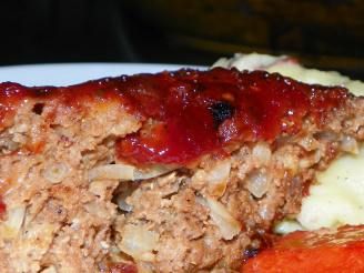 meatloaf with mashed potatoes, carrots and gravy on a plate