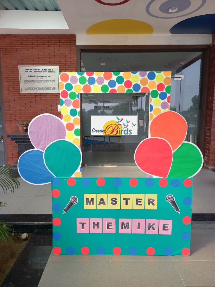 the front door to a building with colorful decorations on it and words written in large letters