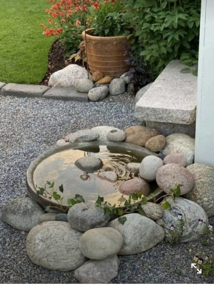 a garden with rocks and water in it