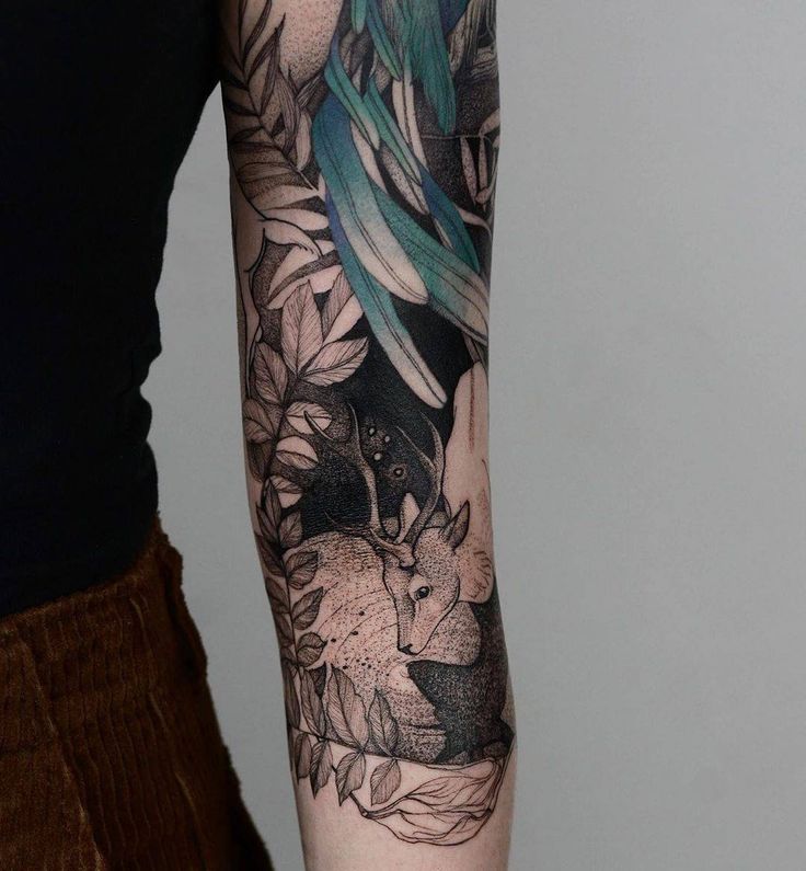 a woman's arm with an animal and flowers tattoo on her left arm, while the other half is black and grey