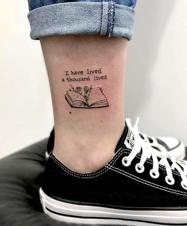 a woman's foot with a book tattoo on her left ankle and the words i have lived in thousand lives