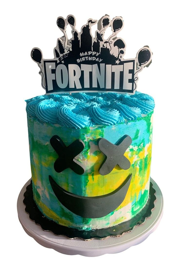 a birthday cake decorated with an image of a smiling face and the words fortnite on top