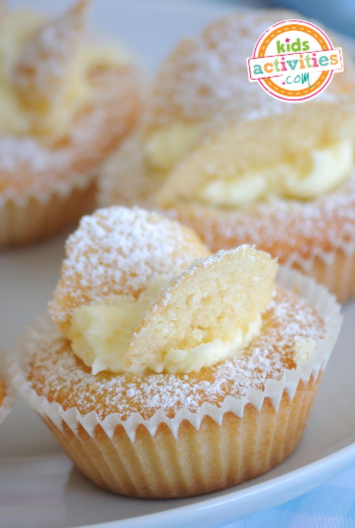 some cupcakes with powdered sugar on them are sitting on a white plate