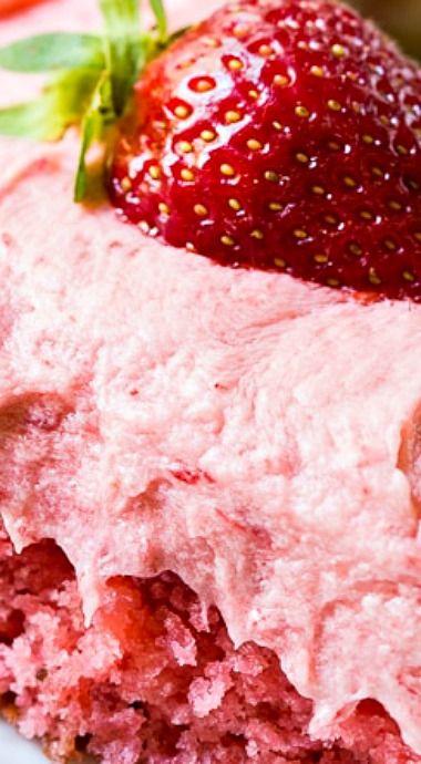 a close up of a piece of cake with strawberries on top