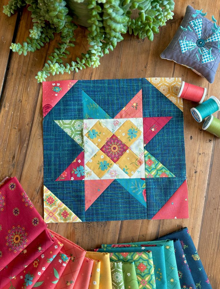 the quilts are laid out on the wooden table