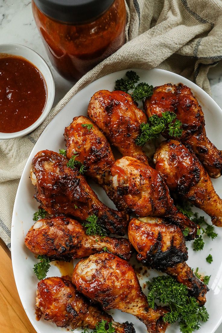 grilled chicken wings on a white plate with ketchup