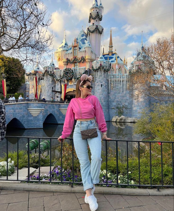 a woman standing in front of a castle