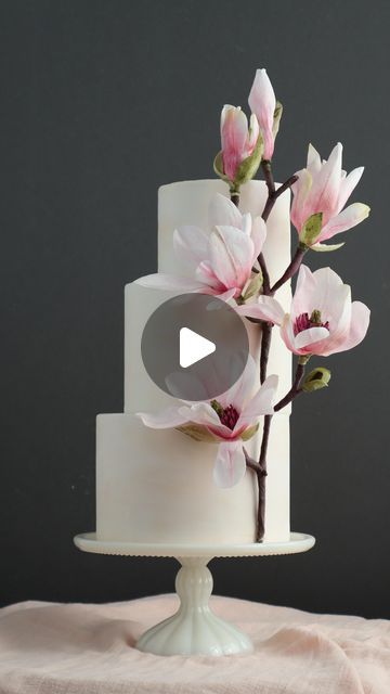 a white cake with pink flowers on top