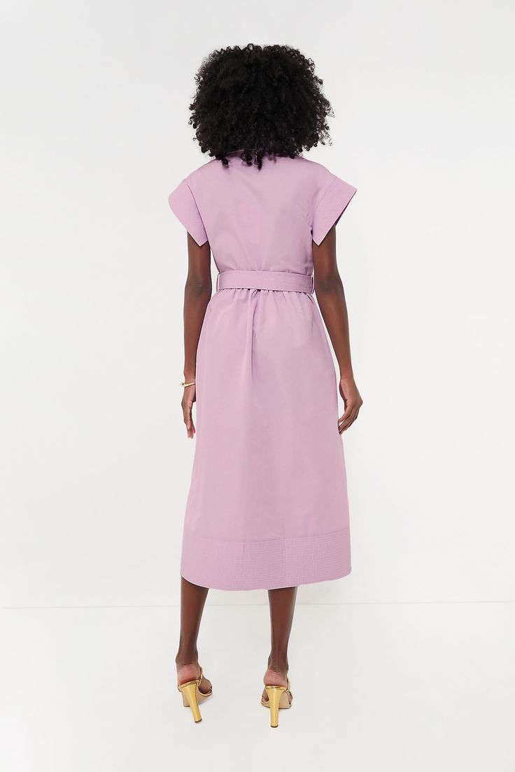 Elegant in its simplicity, the structured and ultra-ladylike Lilac Chloe Dress is done in a textured cotton-blend fabric that is sure to turn heads for its design details. The moire pattern throughout and trapunto stitching on the sleeves, placket, and hemline complete this midi moment, making it feel extra special with minimal effort. Pair with heels or flats, sunnies or statement earrings, for day or night, and rest assured that you look fabulous! Spread collar Short wing sleeves Button front placket Optional adjustable fabric belt with buckle closure (included) Side seam pockets Trapunto stitching on sleeves, placket, and hemline Midi length Moire fabric Material: 80% Polyester, 20% Cotton Care: Dry clean only Modern Cotton Dresses For Daywear, Modern Cotton Daywear Dress, Modern Spring Maxi Dress For Work, Modern Fitted Cotton Dresses, Cotton Dress With French Seams For Work, Modern Cotton Midi Dress, Structured Spring Workwear Dresses, Feminine Cotton Dresses For Work, Spring Work Dress With French Seams