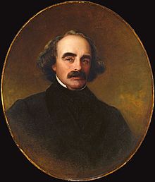 an oval portrait of a man with a mustache and black coat, wearing a white collared shirt