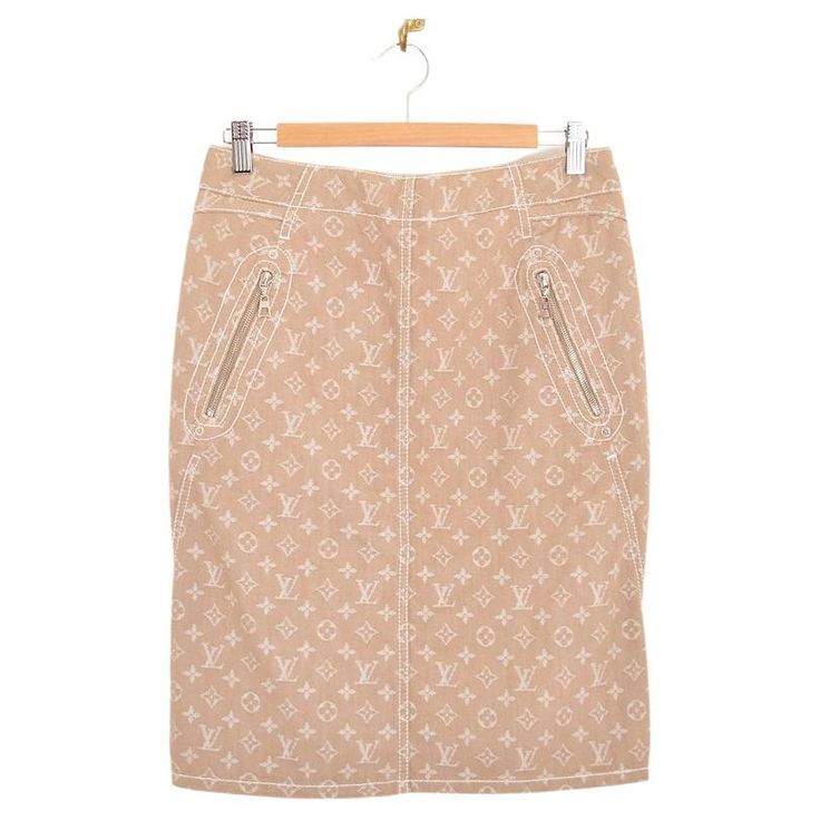 A Louis Vuitton monogram Jacquard denim pencil skirt, in beige & white. With silver-tone metal rivets, two front zip pockets and a back zip and concealed hook-eye fasten. Features; High waisted Louis Vuitton embossed leather rear patch Iconic LV Jacquard monogram throughout 60% Cotton / 40% Polyester Sizing; Waist; 30'' Length; 22'' Recommended Size; UK 10