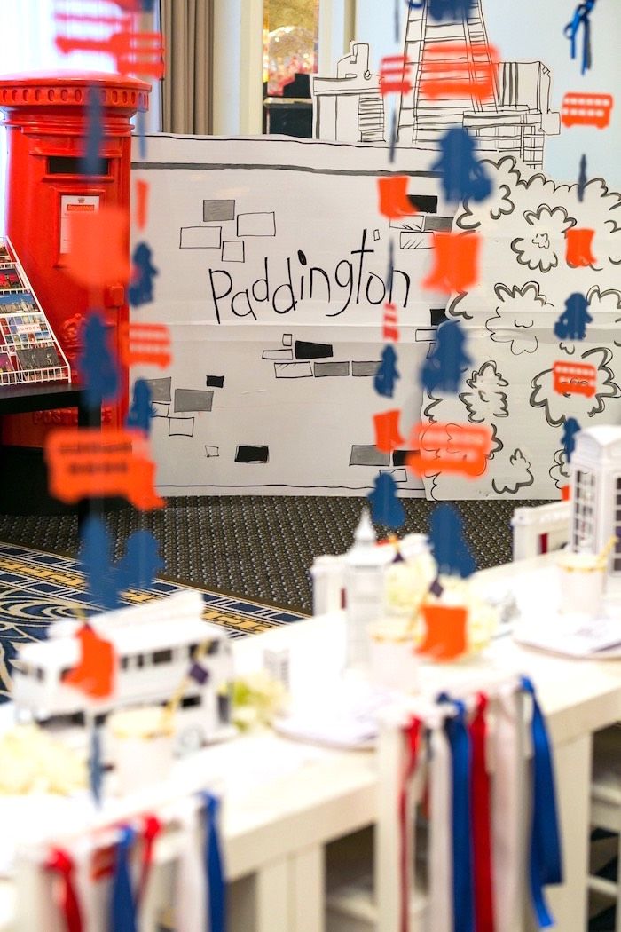 an office decorated with red, white and blue ribbon streamers in front of a sign that reads paddington