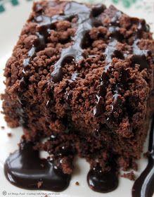 a close up of a piece of cake on a plate with chocolate sauce and drizzle