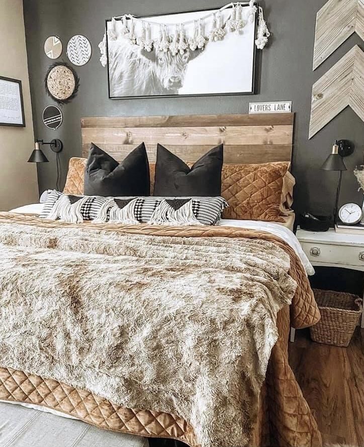 a large bed sitting in a bedroom next to a wooden headboard