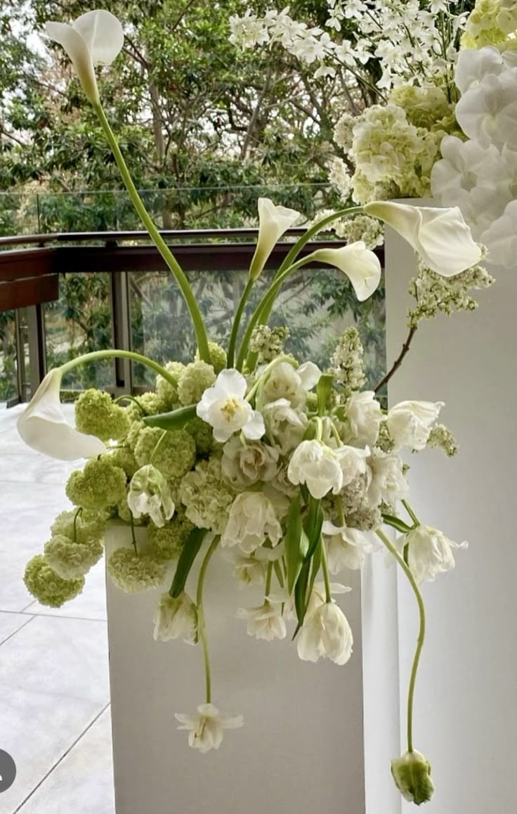 there is a vase with white flowers in it