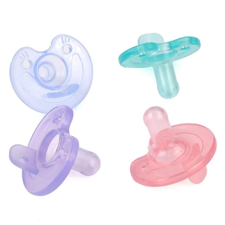 three baby pacifiers sitting next to each other